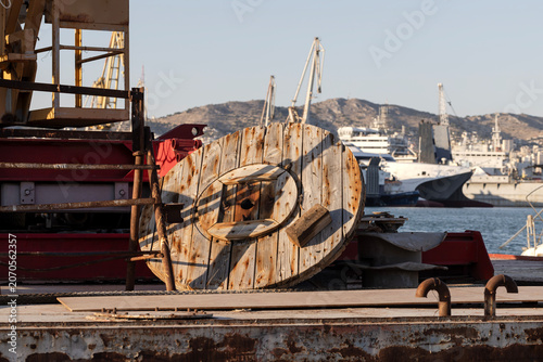An abandoned section of the port with a cable reel in the foreground
