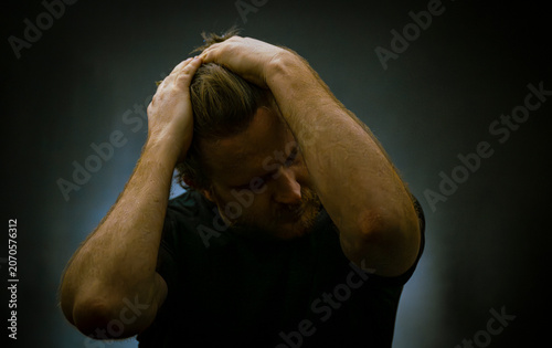 Bilde på lerret Man grips his head in stress or frustration