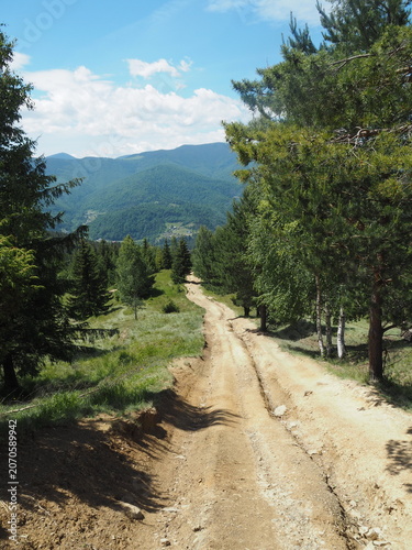 Sandy hiking path on a mountain slope with scenic Carpathian view