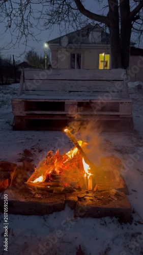 Bonfire flaming at night in winter , atmospheric vertical video	