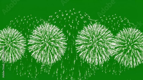 Bright white fireworks burst across a vibrant green background, creating a festive and celebratory atmosphere.