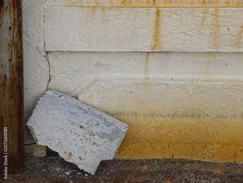 damaged concrete wall with cracks and scratches