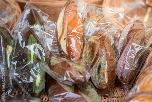 Bild auf Leinwand assorted wrapped stuffed pretzel breads displayed in wicker basket