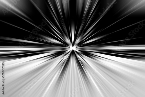 Abstract radial zoom blur in black, white and gray tones on a dark background, forming a sharp monochrome burst with fast radiating lines and a clean, high‑contrast motion effect.