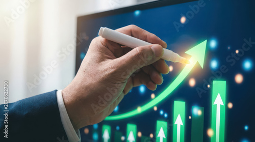 Businessman drawing green upward trend arrow on screen marker
