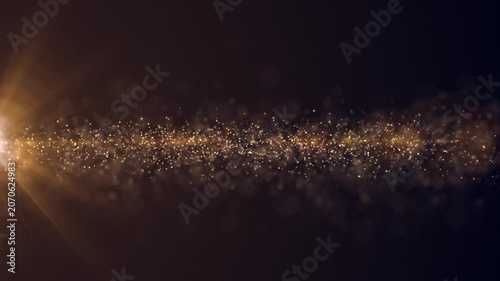 Luxury event background with glittering shiny gold stardust particles streaming across the frame. This golden special occasion background is ideal for events, award ceremonies and talent shows.