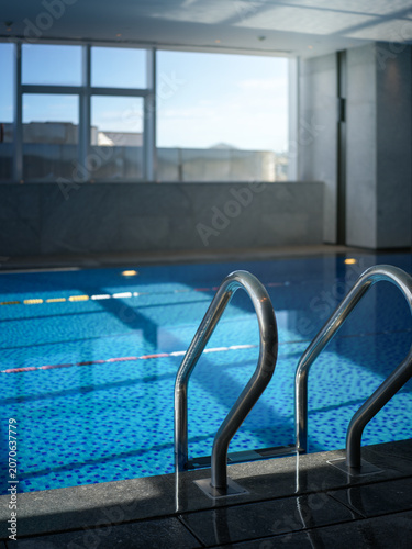Modern luxury indoor constant temperature swimming pool bright sunlight space scene
