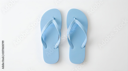 Pair of light blue flip flops isolated on white background.