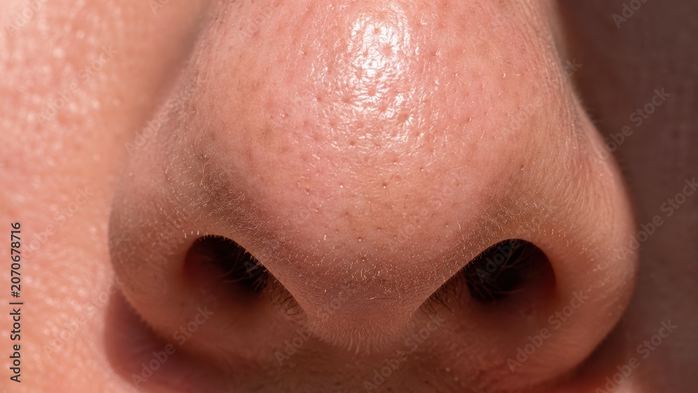 Fototapeta premium Close-up view of human nose with visible skin texture and natural pores detail