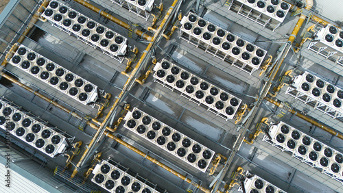 Foto Close up aerial view of industrial HVAC ventilation fans and cooling units in symmetrical rows on a commercial rooftop
