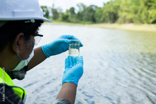 Environmental researchers are collecting water samples for quality analysis.