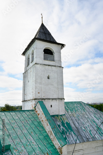 Medieval brick tower with wooden roof and weather vane in Yaroslavl, Russia