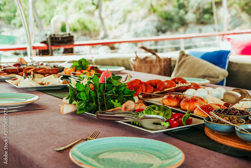 traditional turkish breakfast feast with rich variety on table served on boat gulette for holiday tourists