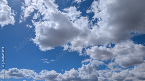 Bright blue sky with fluffy white clouds for a perfect day, background, texture