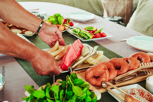 traditional turkish breakfast feast with rich variety on table photos series, fruit plate with watermelon and melon slices, fried dough pisi
