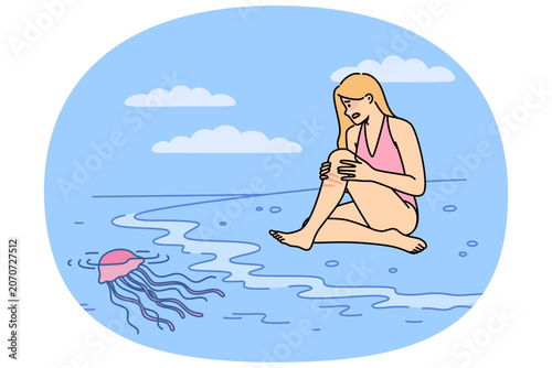 Jellyfish left burn on woman body after coming into contact with underwater in tropical ocean. Wound from jellyfish causes irritation and redness on skin of girl in need of medicinal ointment