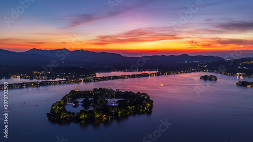 Sunset Lake with Islands and Mountain Silhouettes