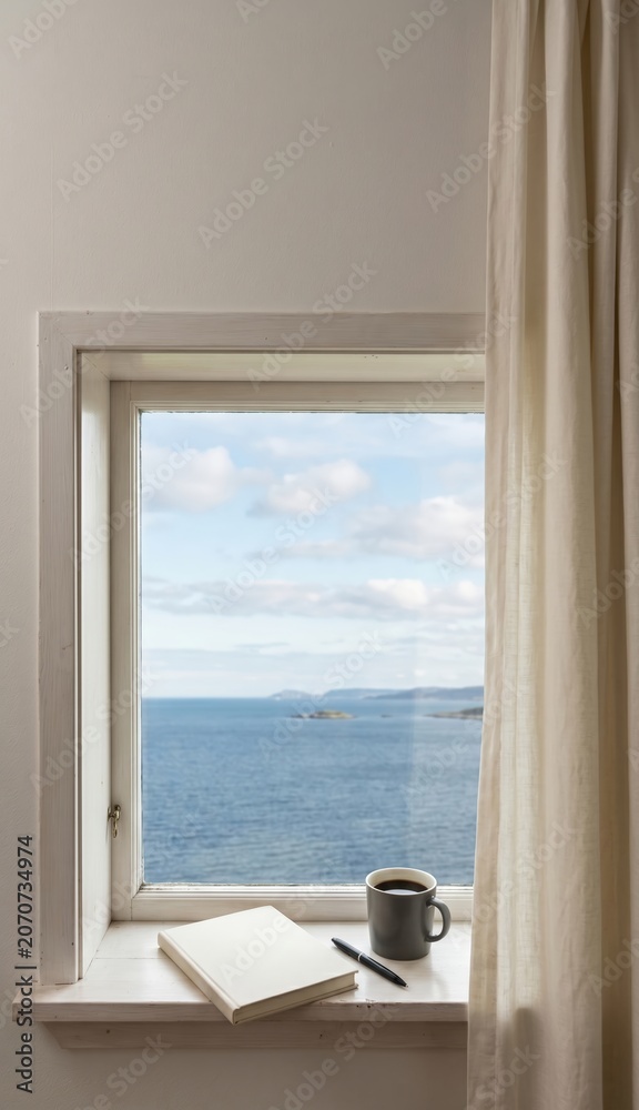Fototapeta premium Cabin window overlooking sea with coffee mug and notebook