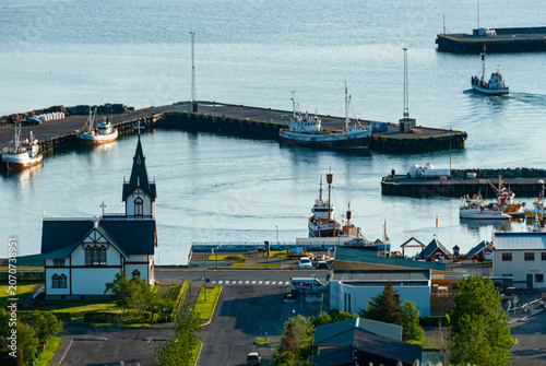 Bild auf Leinwand Elevated view of Húsavík Harbor Iceland with the iconic Húsavík Church fishing b