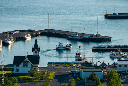 Quadro su tela Elevated view of Húsavík Harbor Iceland with the iconic Húsavík Church fishing b