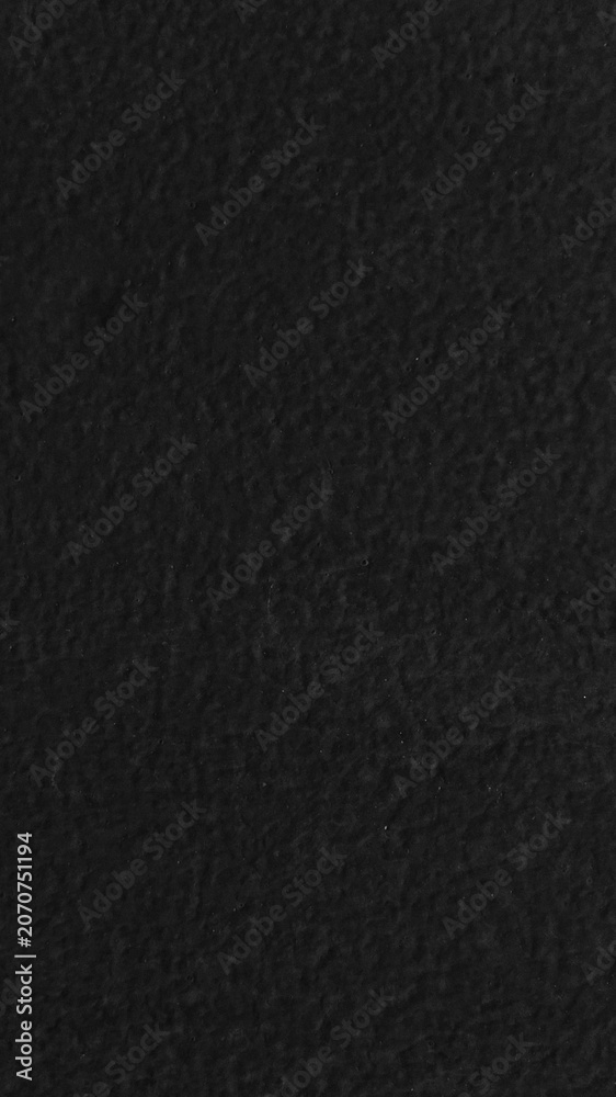 Fototapeta premium Dark textured black mobile wallpaper with a subtle, rough surface for a dramatic effect