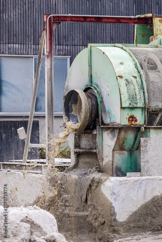 Industrial machinery discharging slurry