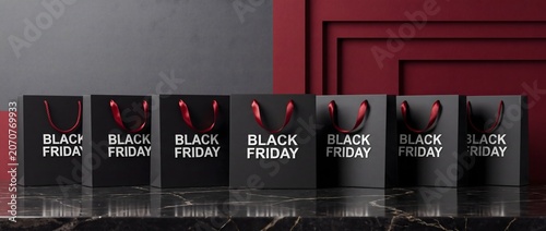 Row of Seven Black Shopping Bags Lined Up on Marble Surface Against Dark Red and Gray Background
