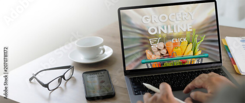 Person Using Laptop for Convenient Online Grocery Shopping and Home Food Delivery Services at a Desk
