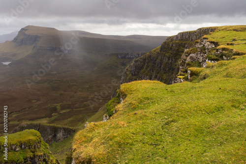 Dramatic mountain cliffs landscape formed by a landslide with heavy rainfall on the green isle of Skye in Scotland.