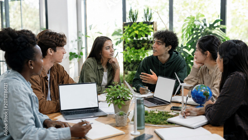Young activists planning local climate action project in community workspace