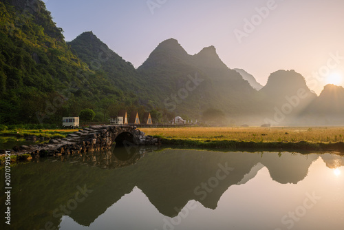 Sunrise Reflection Over Karst Mountains and Stone Bridge in Guilin, China