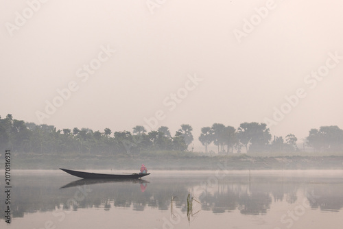 A fisherman fishing at Purbasthali oxbow lake in the morning, India