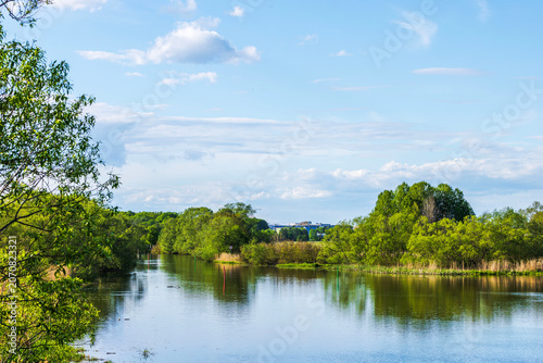Beautiful view of navigable river with channel markers and lush green trees. Sweden.