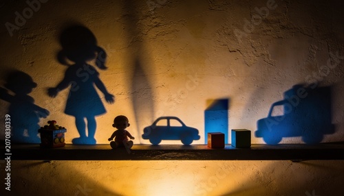 Shadow Play Delight: A charming display of shadow puppets, featuring children's toys and figures, come to life through the magic of light and shadow, sparking imagination and wonder.
