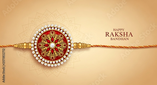 Rakhi bracelet with red gemstones and gold filigree on a beige background