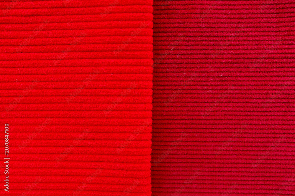 Fototapeta premium Red and burgundy corduroy fabrics comparison showing fine and wide wale textures