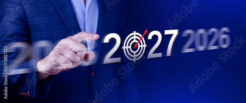 Vision 2027. Business Target for 2027, Businessman Pointing at Year 2027 with Dartboard Target Icon, Financial Goals and Business Strategy, Planning and Investment, not ai