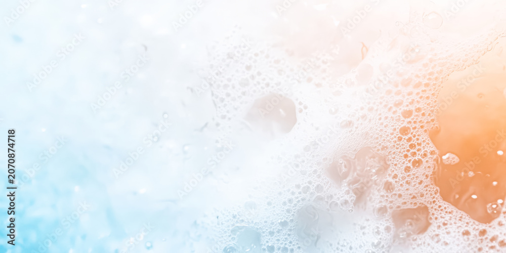 Fototapeta premium Clear water surface with bubbles and a gradient of blue and orange hues. High resolution digital texture. Suitable for backgrounds, design projects, and aquatic themed visuals.