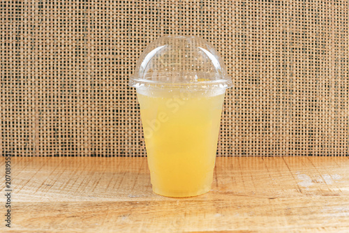 the fizzy stream of orangeade with soda poured over ice, lifting the fruit slices in an effervescent dance within the glass.
