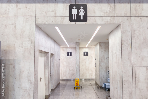 Entrance to a public toilet. Two doors to the public toilet for women and men. Indicative sign for toilet cubicles for men and women.
