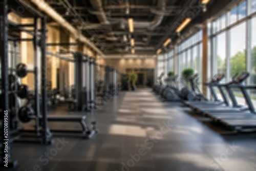 Blurred gym interior fitness center background modern empty workout room abstract training facility wellness club health equipment bokeh