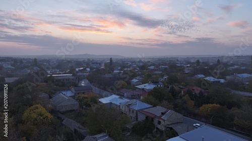 Aerial drone shot of the beautiful city of Gyumri in Armenia, showcasing its historic architecture, busy city squares, streets, and the famous landmark Holy Saviour's Church during autumn.


