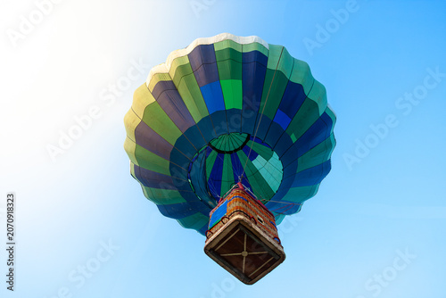 Colorful hot air balloon viewed from below in the blue sky