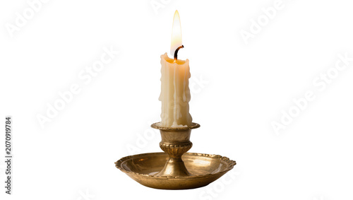 Fotografie Isolated vintage brass candlestick with a burning candle casting warm light and