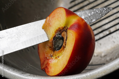 Fresh Peach Half with Kitchen Knife – Healthy Fruit Preparation Concept