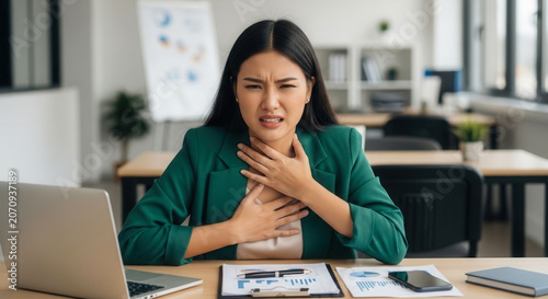Asian woman experiencing anxiety sweat and panic attack at office desk, mental health awareness and workplace stress