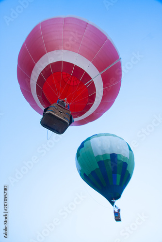 Colorful Hot Air Balloons Flying Against Blue Sky Viewed from Below