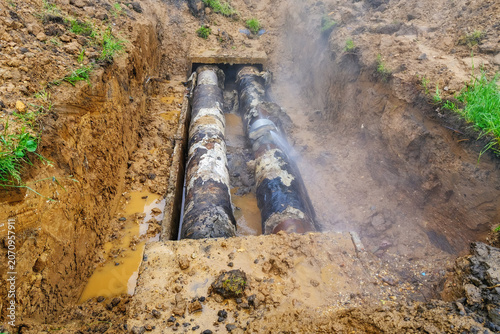 Tablou pe pânză Excavated trench with outdated corroded water pipes in unsafe condition leaking