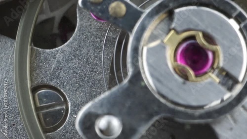Detail of the balance wheel and hairspring of a working wristwatch mechanism.