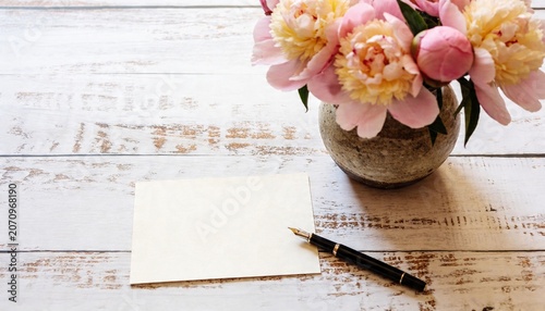 Top View Blank Invitation Card Mockup with Pink Peonies Bouquet, Fountain Pen and Warm Sunlight Shadows on White Rustic Wooden Table, Aesthetic Flat Lay Floral Greeting Card Background